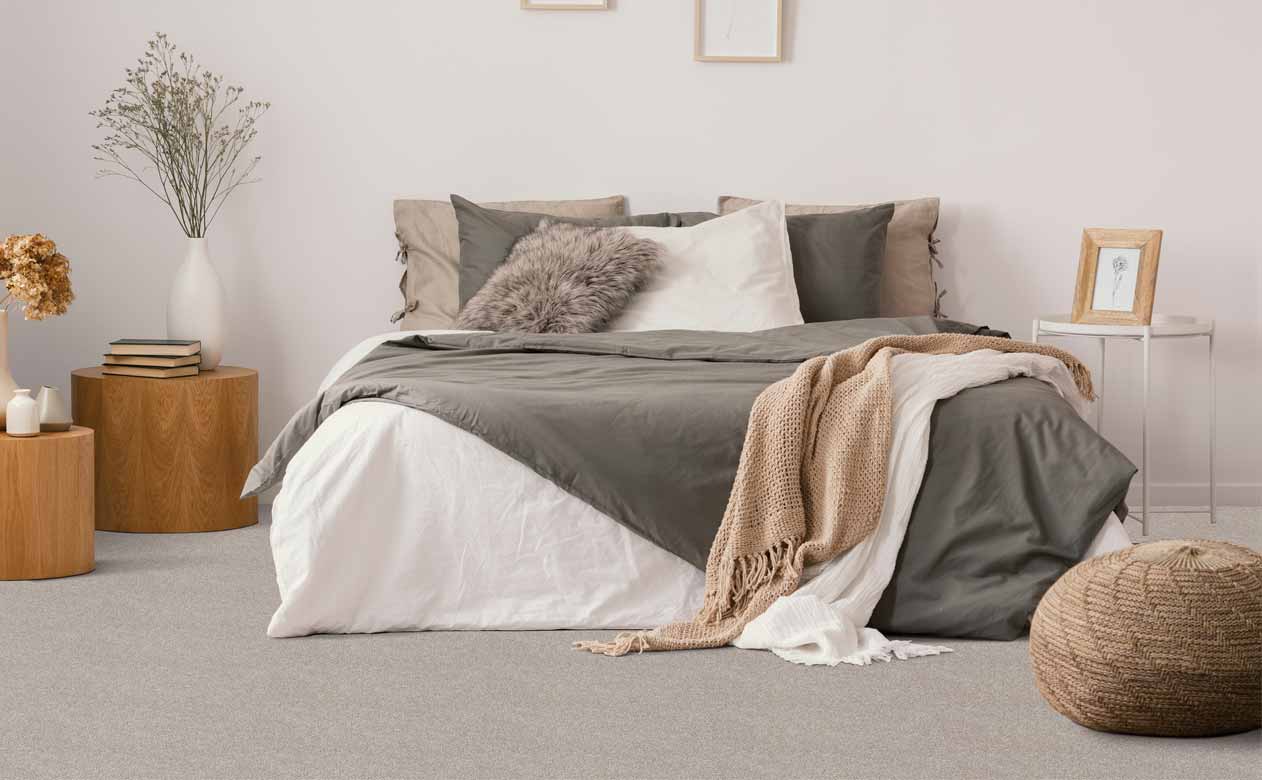 grey carpet in a bedroom with wooden side tables