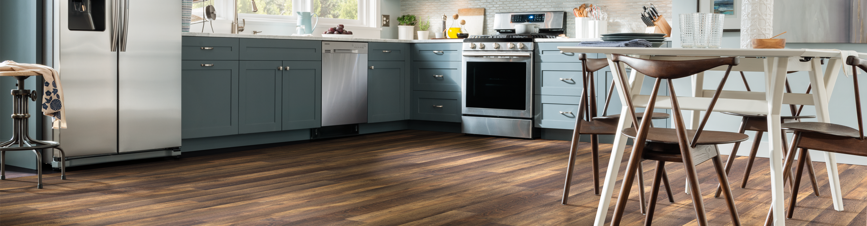 Dark, rustic plank vinyl floors in casual kitchen.