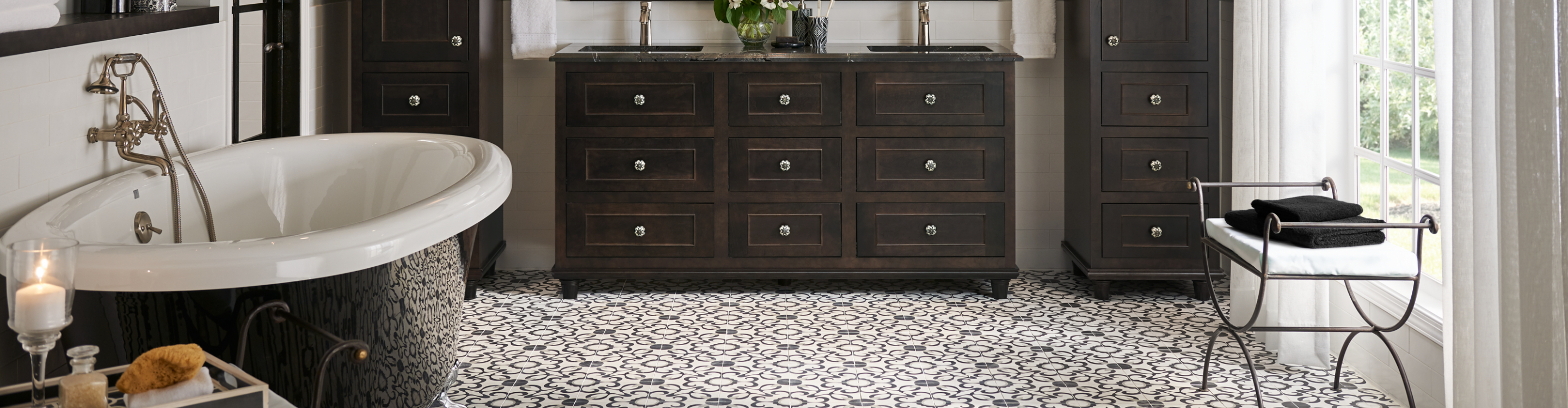 Bathroom with patterned tile floors and wood cabinets. 